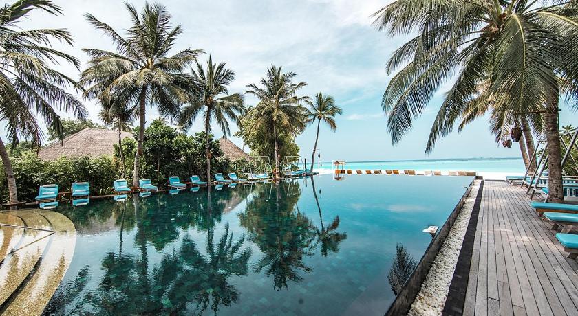 Maldives resort pool and sunbeds for all inclusive holiday