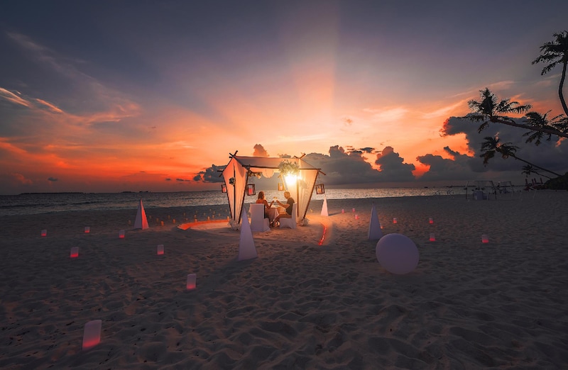 Romantic beach dinner Maldives with sunset decor