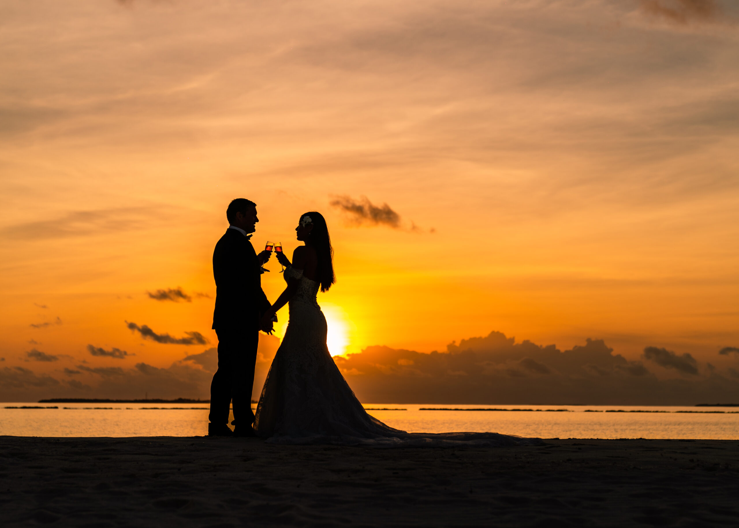 Maldives honeymoon couple sunset celebration