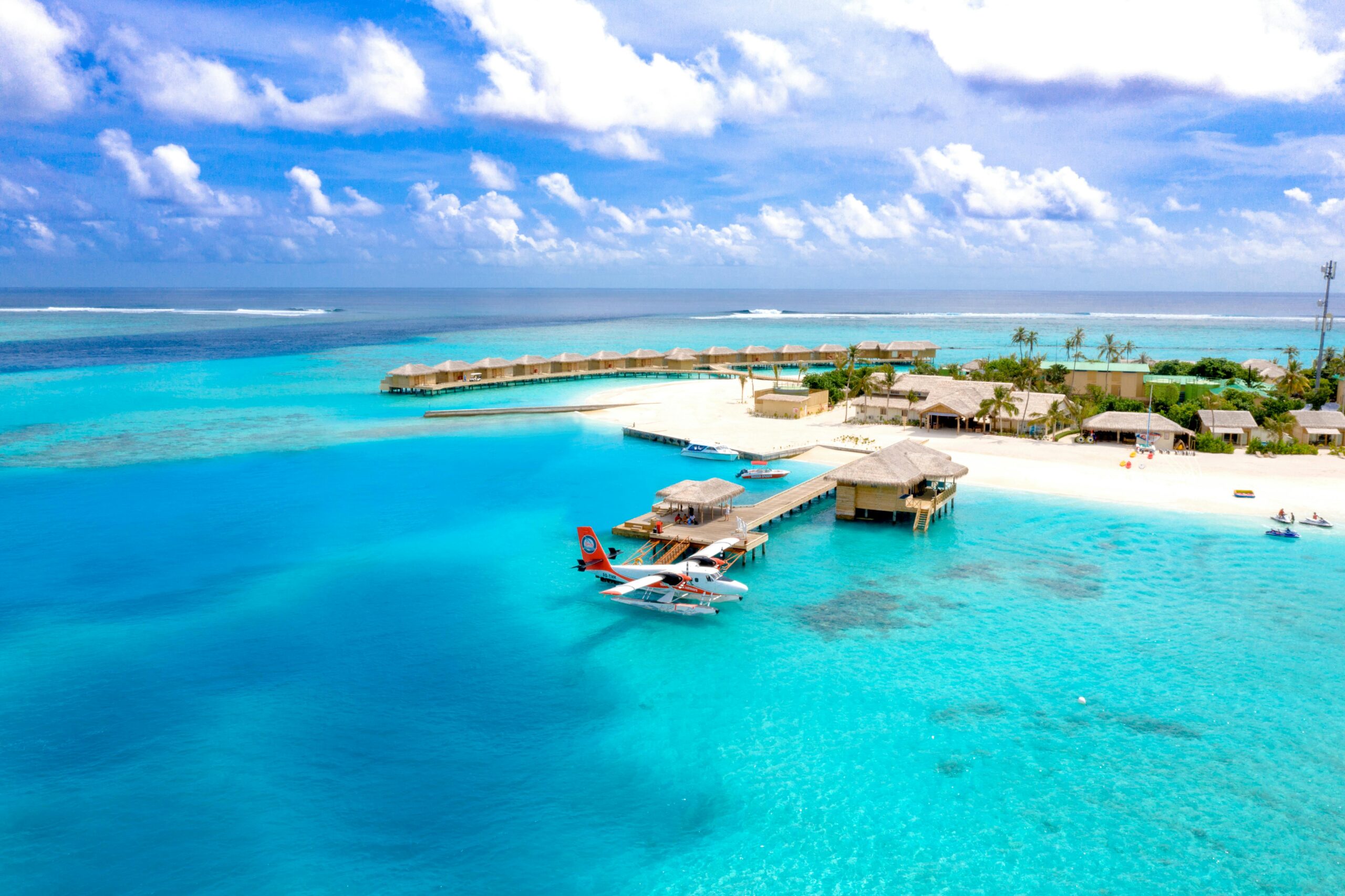 All inclusive Maldives resort aerial view with lagoon and water villas